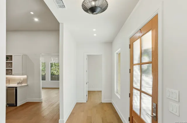 a kitchen with kitchen island a counter top space a sink stainless steel appliances and cabinets