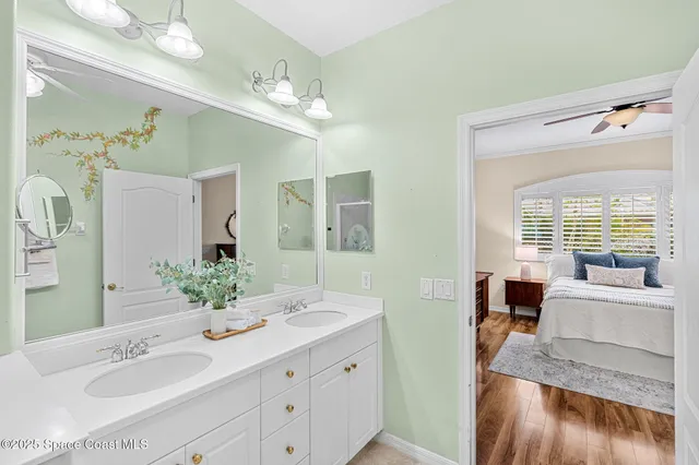 a bathroom with a double vanity sink mirror and shower