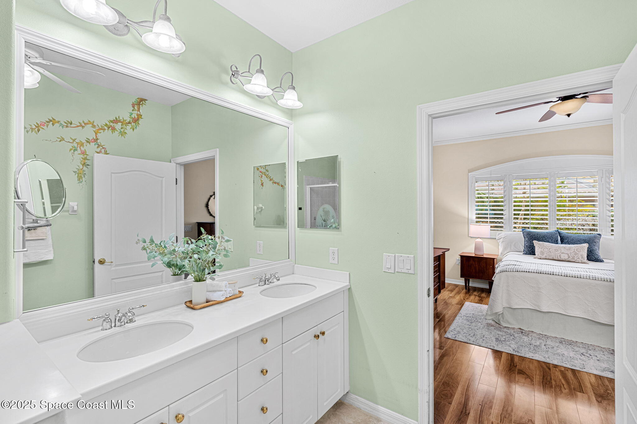 2700 Camberly Circle Melbourne, FL 32940 - Photo 16 of 50 a spacious bathroom with a double vanity sink and a mirror