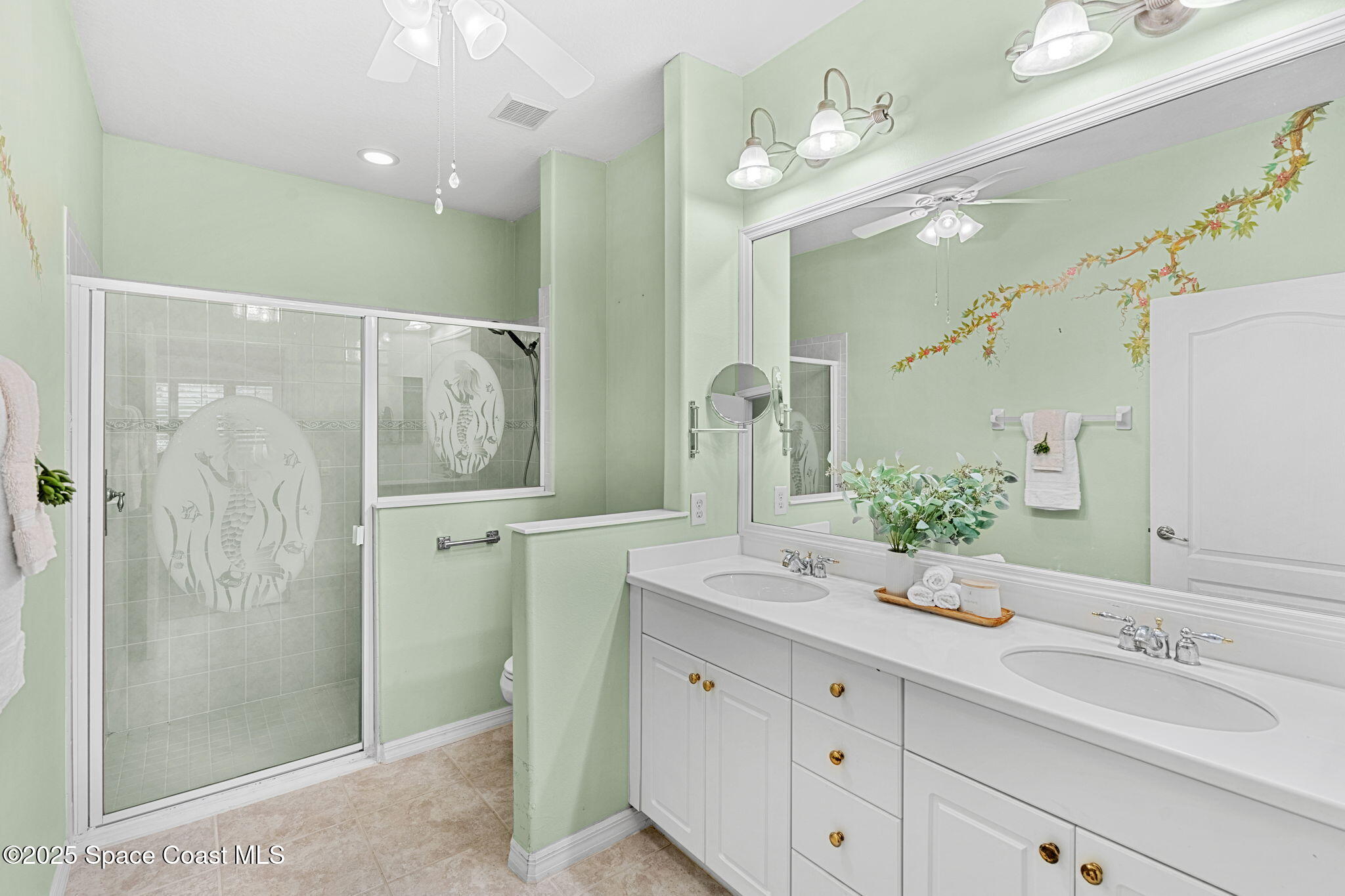 2700 Camberly Circle Melbourne, FL 32940 - Photo 17 of 50 a bathroom with a double vanity sink mirror and shower