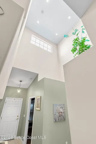 a living room with furniture kitchen view and a chandelier