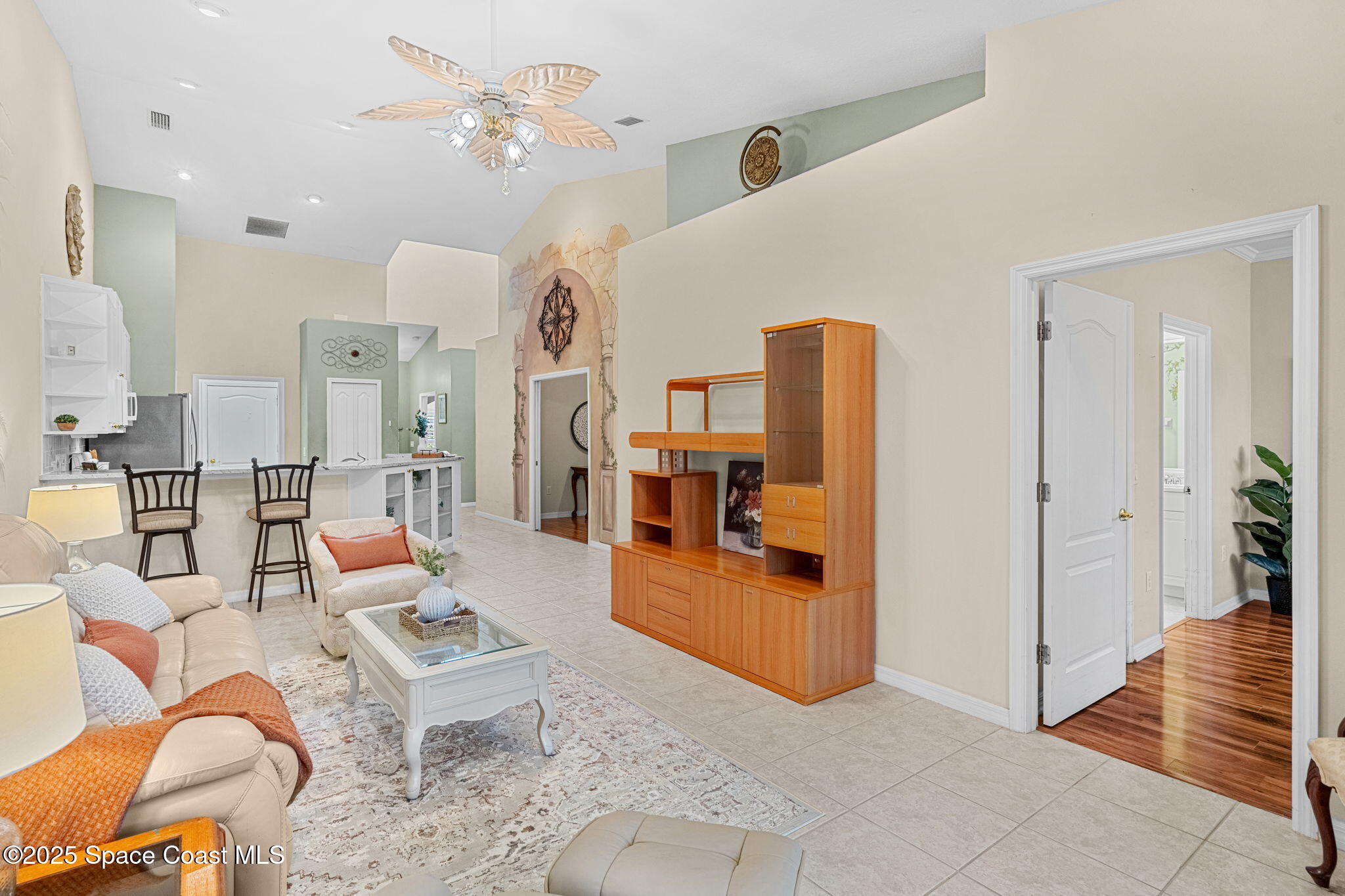 2700 Camberly Circle Melbourne, FL 32940 - Photo 5 of 50 a living room with furniture kitchen view and a chandelier