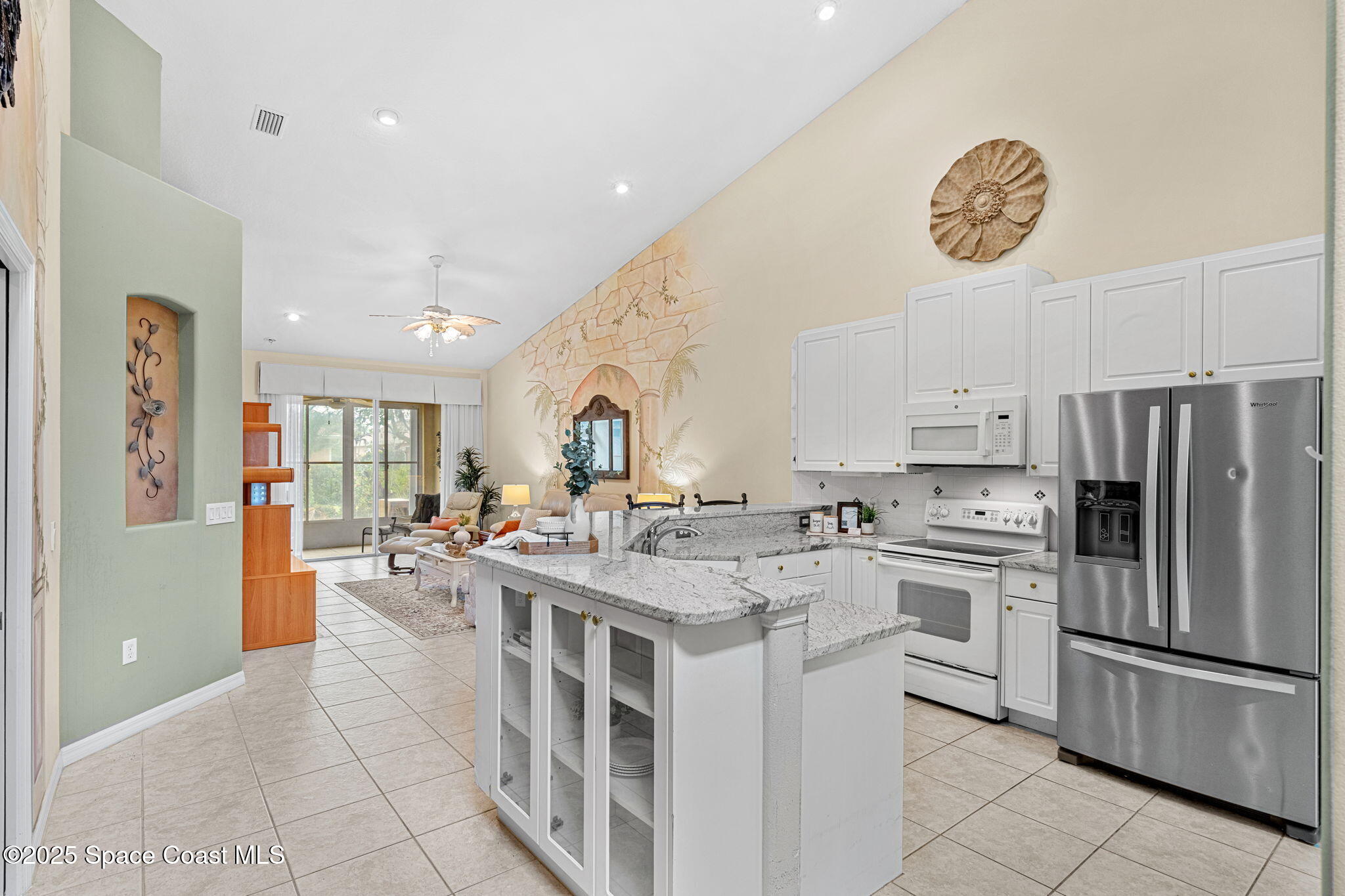 2700 Camberly Circle Melbourne, FL 32940 - Photo 9 of 50 a kitchen with cabinets and stainless steel appliances