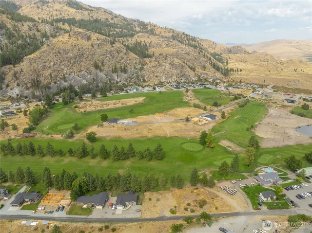 an aerial view of mountain with residential house and ocean view