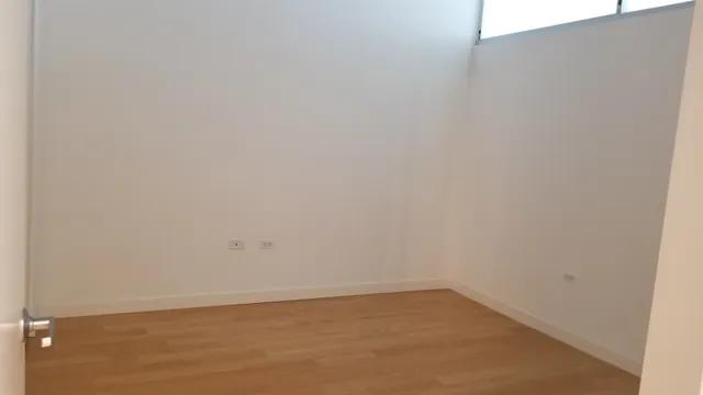 a view of a floor to ceiling window with wooden floor