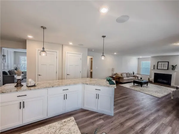 a living room with furniture wooden floor and a table