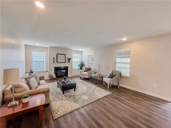a living room with furniture and view of kitchen