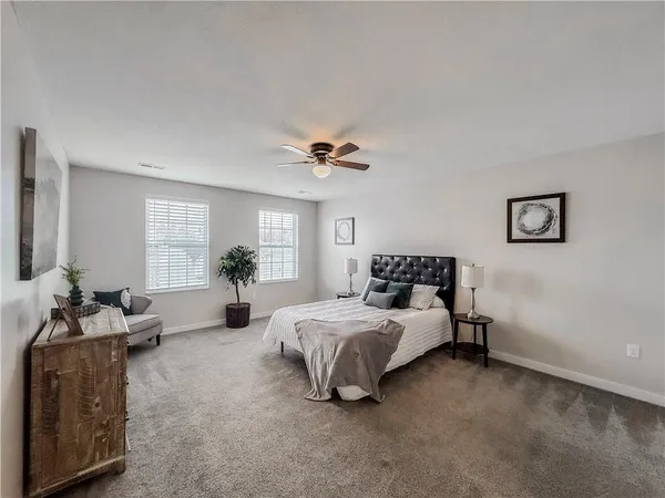 a bed room with a bed and a potted plant