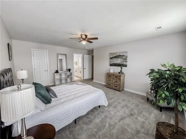 a living room with furniture hard wood floor and a ceiling fan