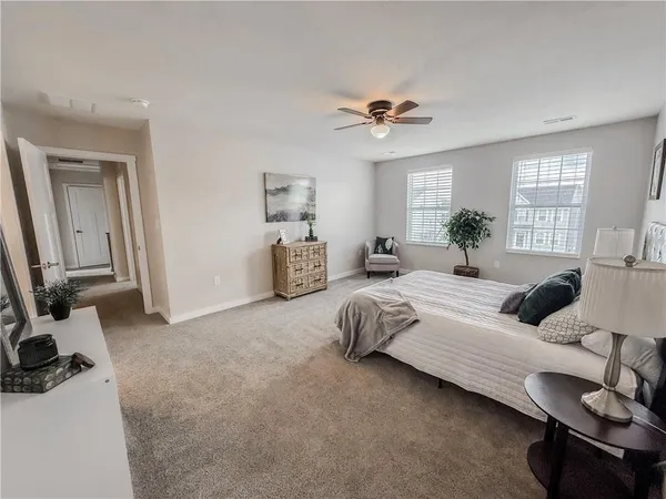 a bedroom with a bed and a potted plant