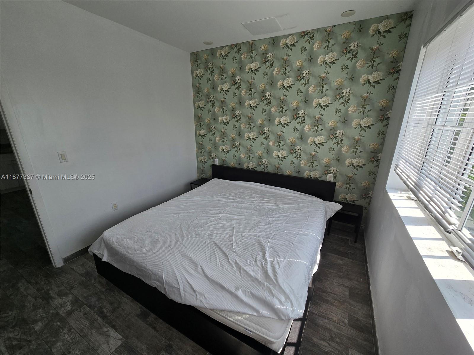 1345 Pennsylvania Avenue, Unit 2C Miami Beach, FL 33139 - Photo 12 of 18 a bed sitting in a bedroom next to a window