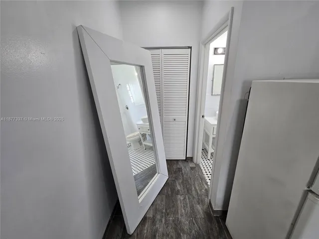 a bathroom with a sink a toilet a mirror and shower