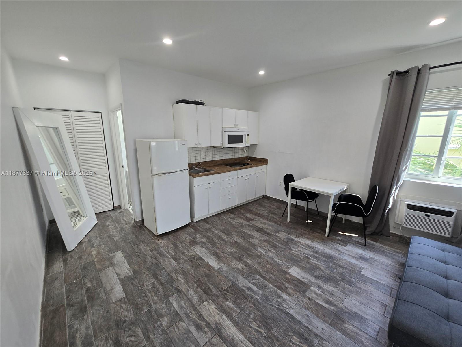 1345 Pennsylvania Avenue, Unit 2C Miami Beach, FL 33139 - Photo 2 of 18 a living room with furniture and a wooden floor