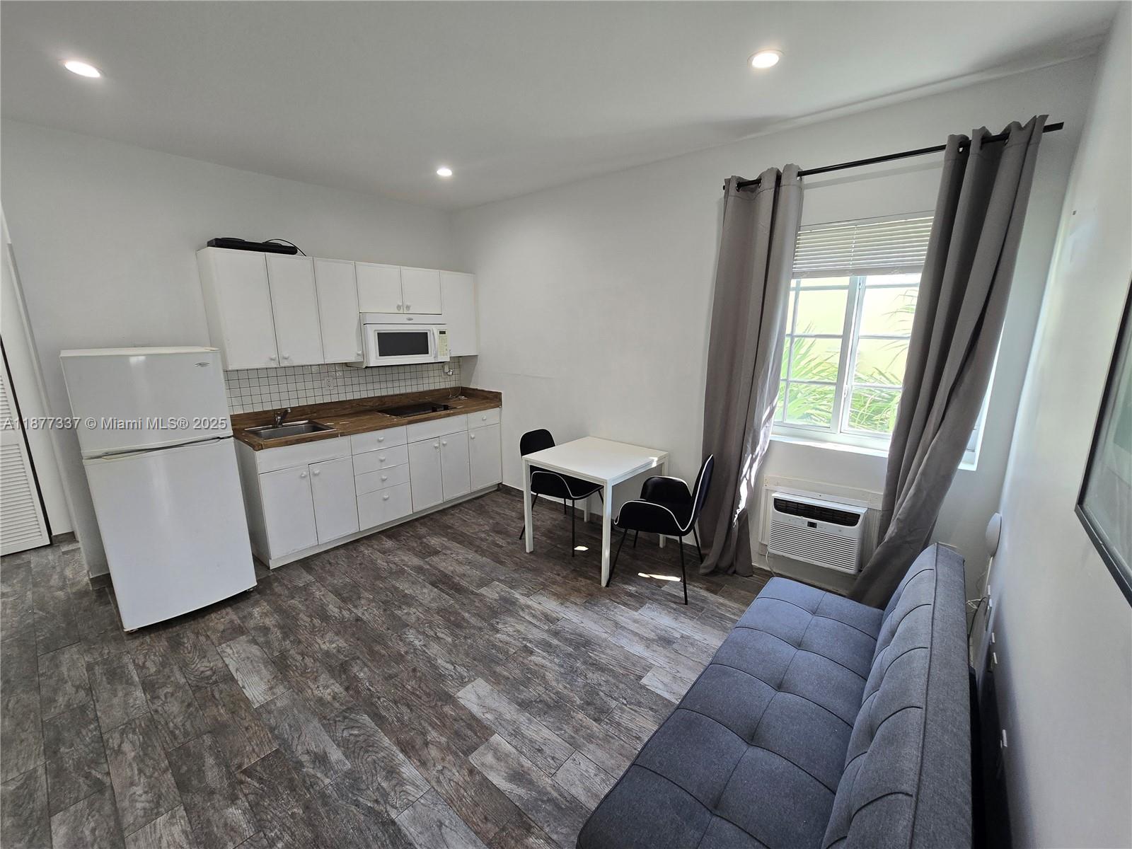 1345 Pennsylvania Avenue, Unit 2C Miami Beach, FL 33139 - Photo 3 of 18 a kitchen with stainless steel appliances granite countertop a refrigerator and a stove top oven