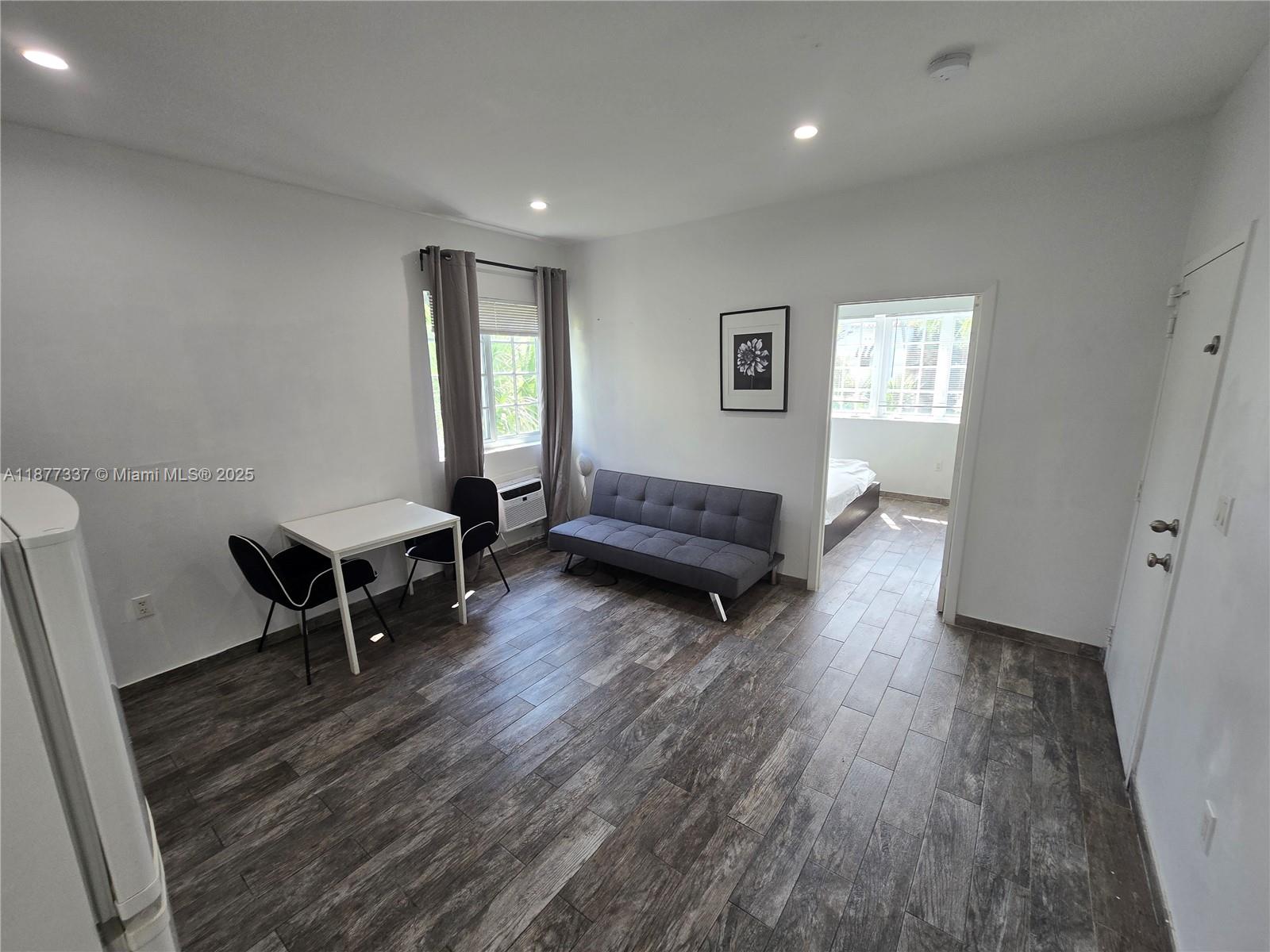 1345 Pennsylvania Avenue, Unit 2C Miami Beach, FL 33139 - Photo 6 of 18 a living room with furniture and a wooden floor