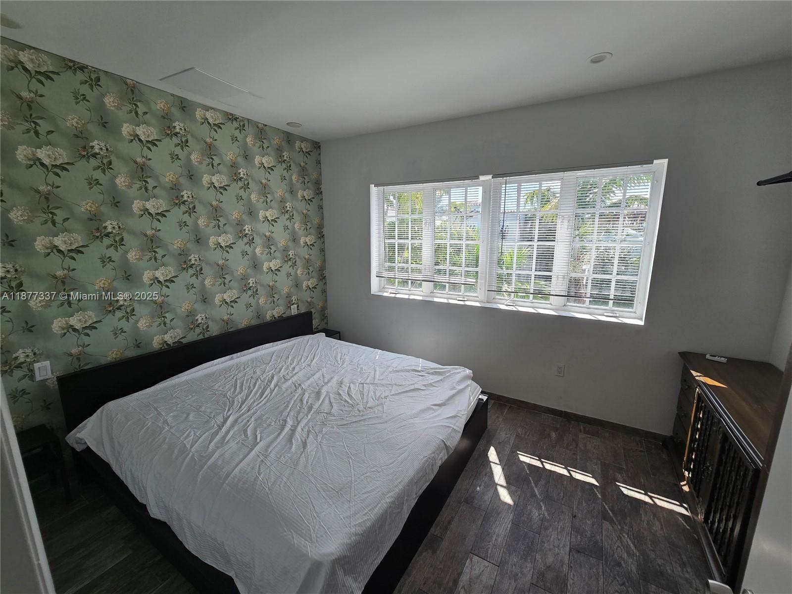 1345 Pennsylvania Avenue, Unit 2C Miami Beach, FL 33139 - Photo 8 of 18 a bed sitting in a bedroom next to a window
