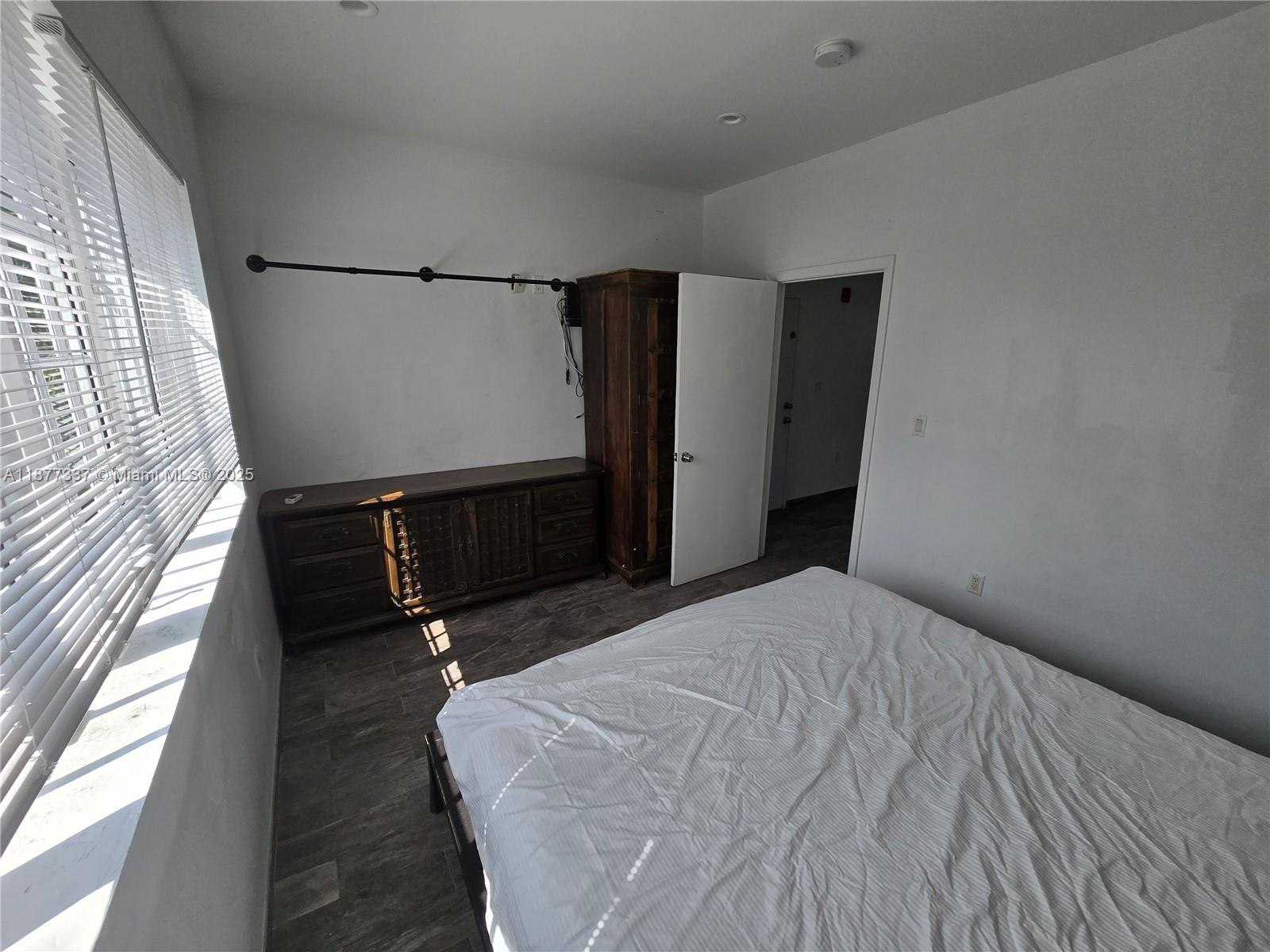 1345 Pennsylvania Avenue, Unit 2C Miami Beach, FL 33139 - Photo 10 of 18 a bedroom with a bed and a window