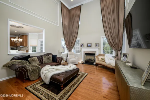 a living room with furniture a fireplace and a large window