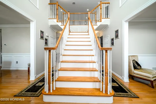 a view of entryway dining room and hall with wooden floor