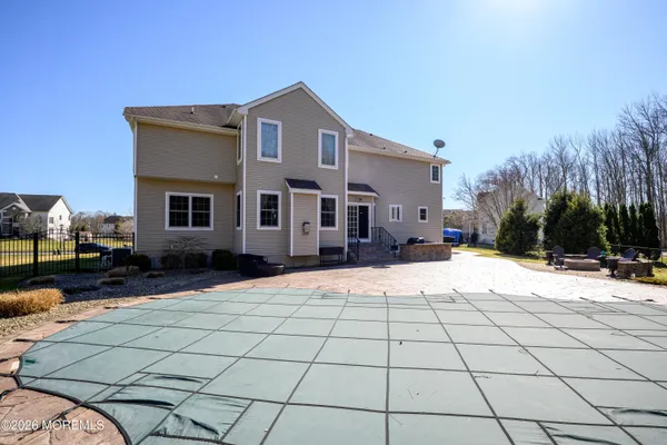 a spacious bedroom with a bed and a chandelier