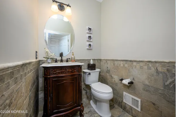 a view of a hallway with wooden floor and stairs