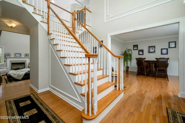 a front view of a house with a big yard and a large tree