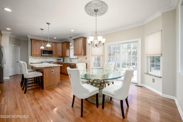 a kitchen with stainless steel appliances granite countertop wooden cabinets a stove a sink and a refrigerator