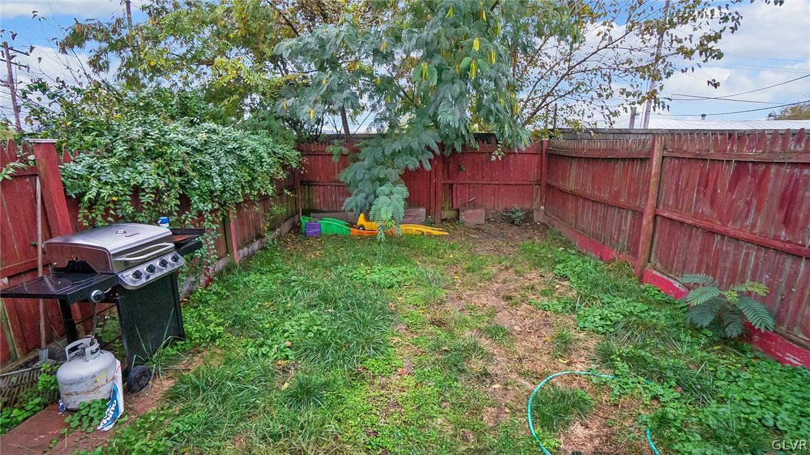 1340 Butler Street Easton, PA 18042 - Photo 18 of 18 a view of backyard with wooden fence and large trees
