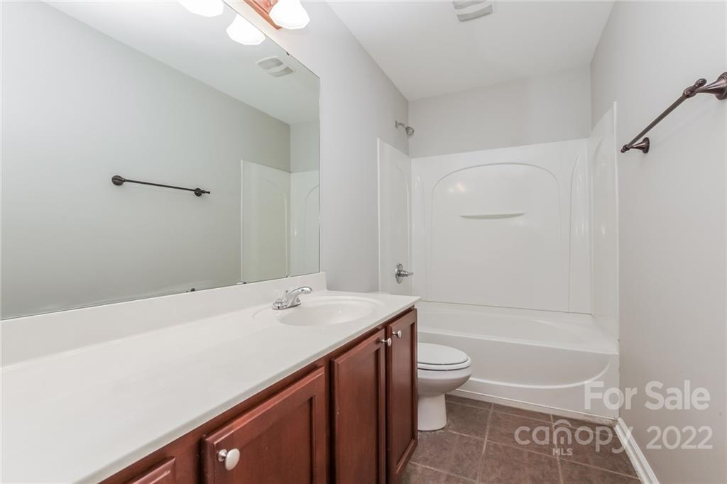 6415 Hermsley Road Charlotte, NC 28278 - Photo 14 of 15 a bathroom with a sink a toilet and shower