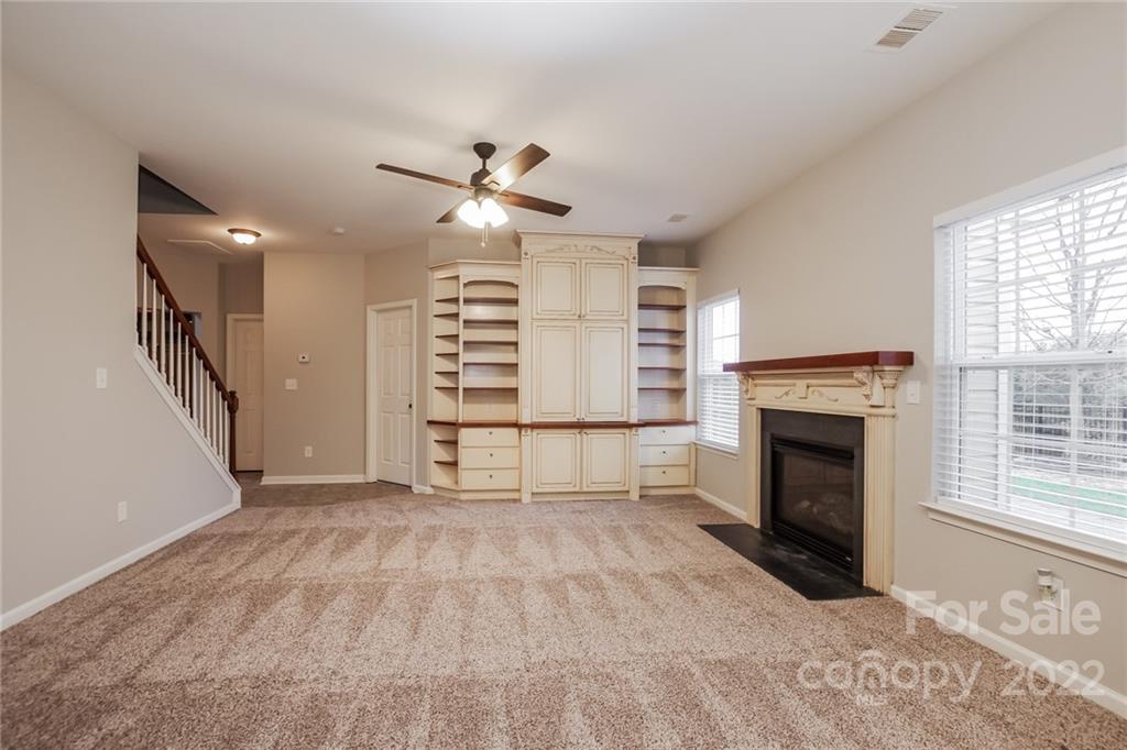 6415 Hermsley Road Charlotte, NC 28278 - Photo 3 of 15 a view of an empty room with a fireplace and a window