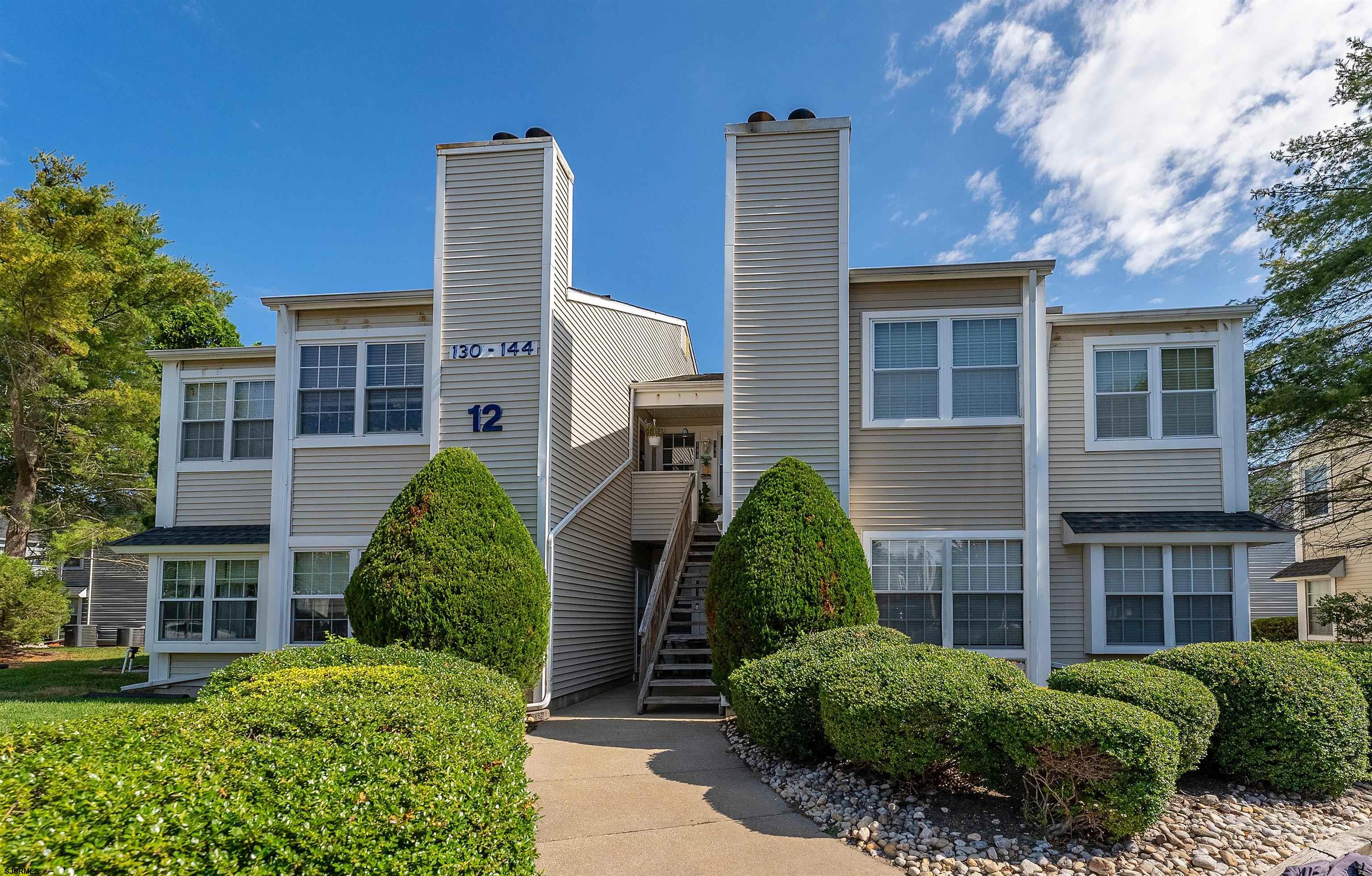 a view of a house with windows and plants