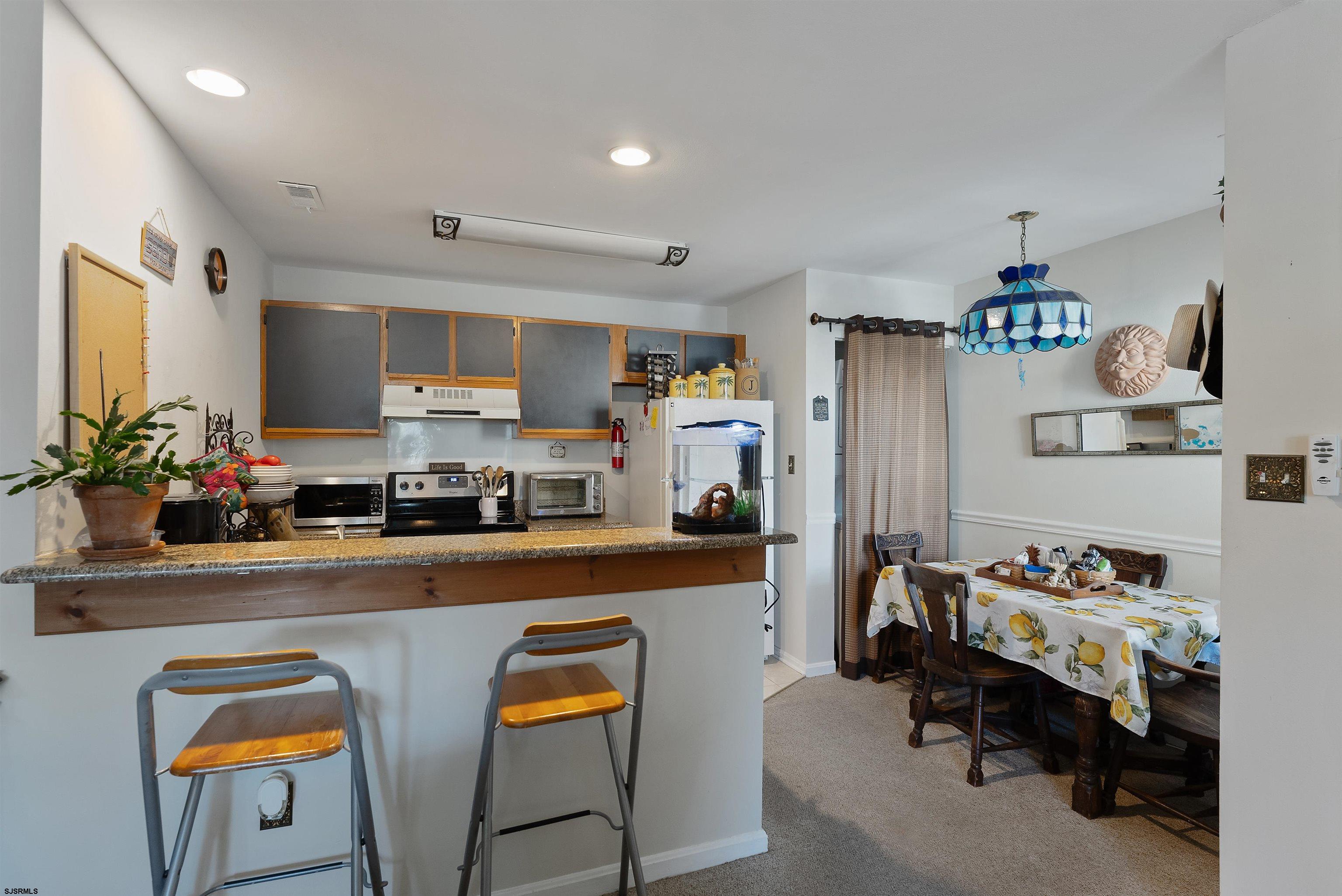 144 Meadow Ridge Road, Unit 144 Galloway Township, NJ 08205 - Photo 11 of 16 a kitchen with granite countertop appliances and cabinets