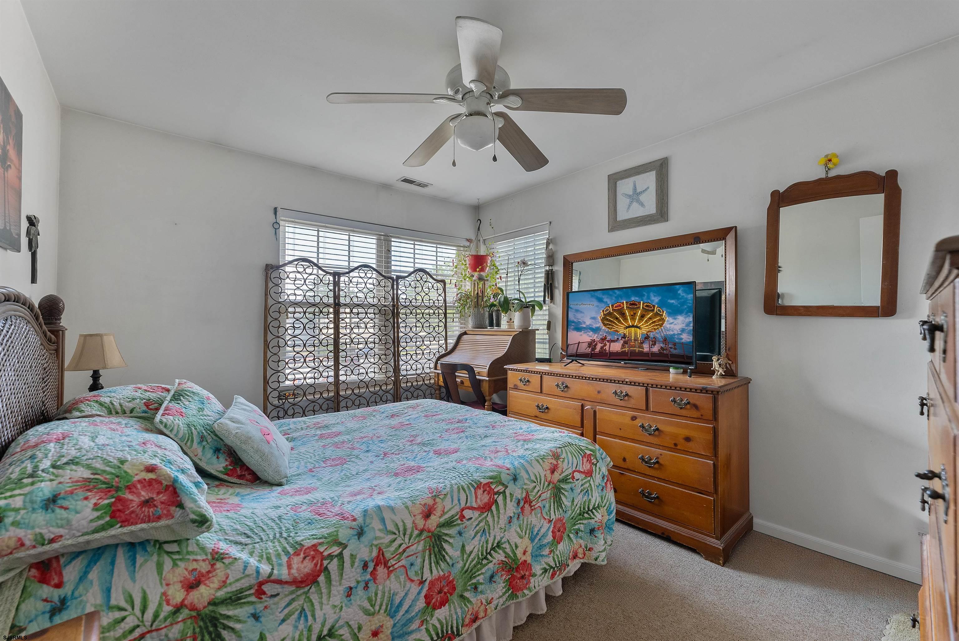 144 Meadow Ridge Road, Unit 144 Galloway Township, NJ 08205 - Photo 13 of 16 a bedroom with a bed window and a flat screen tv