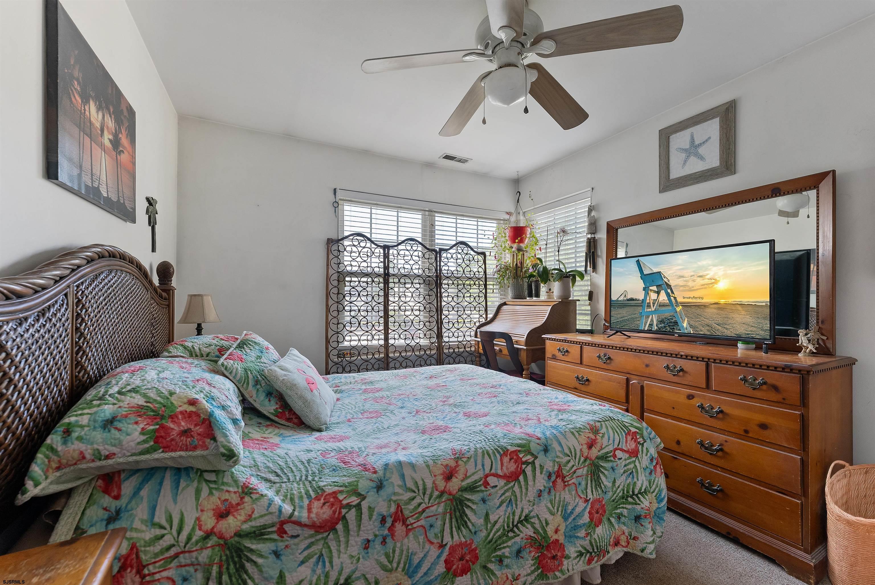 144 Meadow Ridge Road, Unit 144 Galloway Township, NJ 08205 - Photo 14 of 16 a bedroom with a bed and a flat screen tv