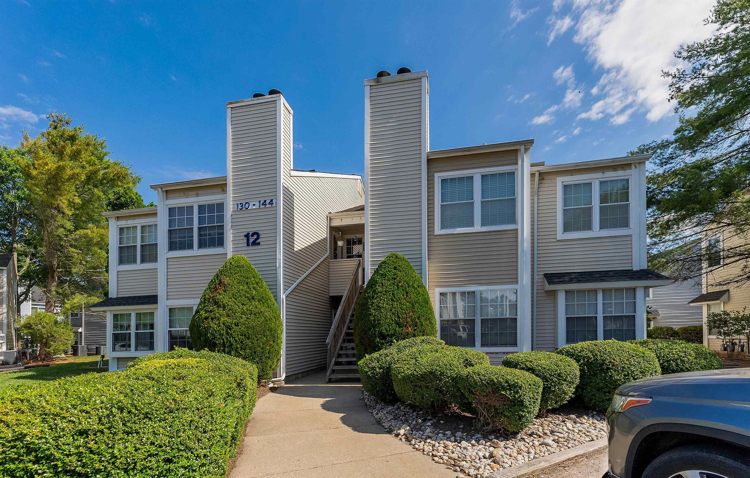 144 Meadow Ridge Road, Unit 144 Galloway Township, NJ 08205 - Photo 2 of 16 a view of a house with a yard and plants
