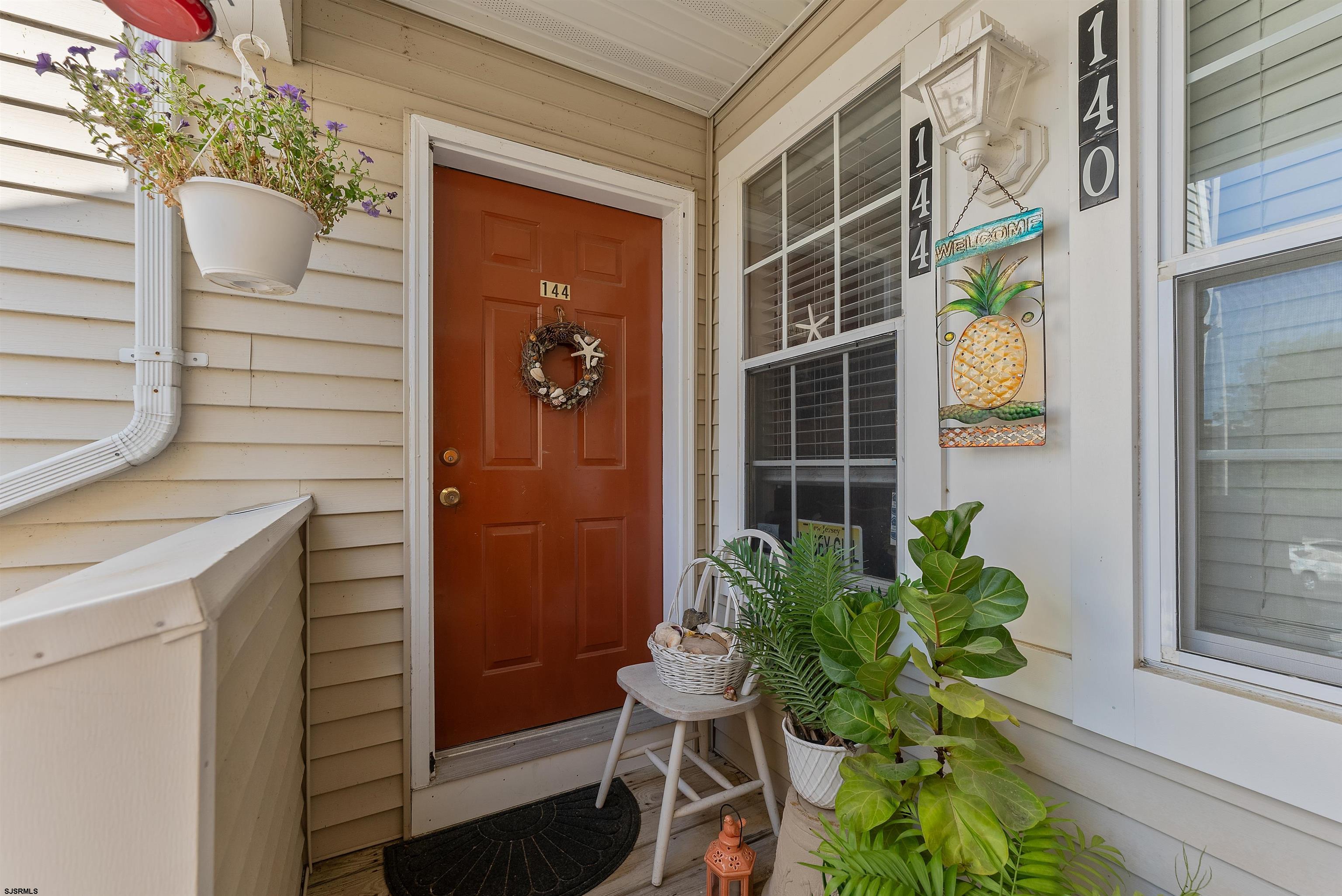 144 Meadow Ridge Road, Unit 144 Galloway Township, NJ 08205 - Photo 3 of 16 a potted plant sitting in front of a door