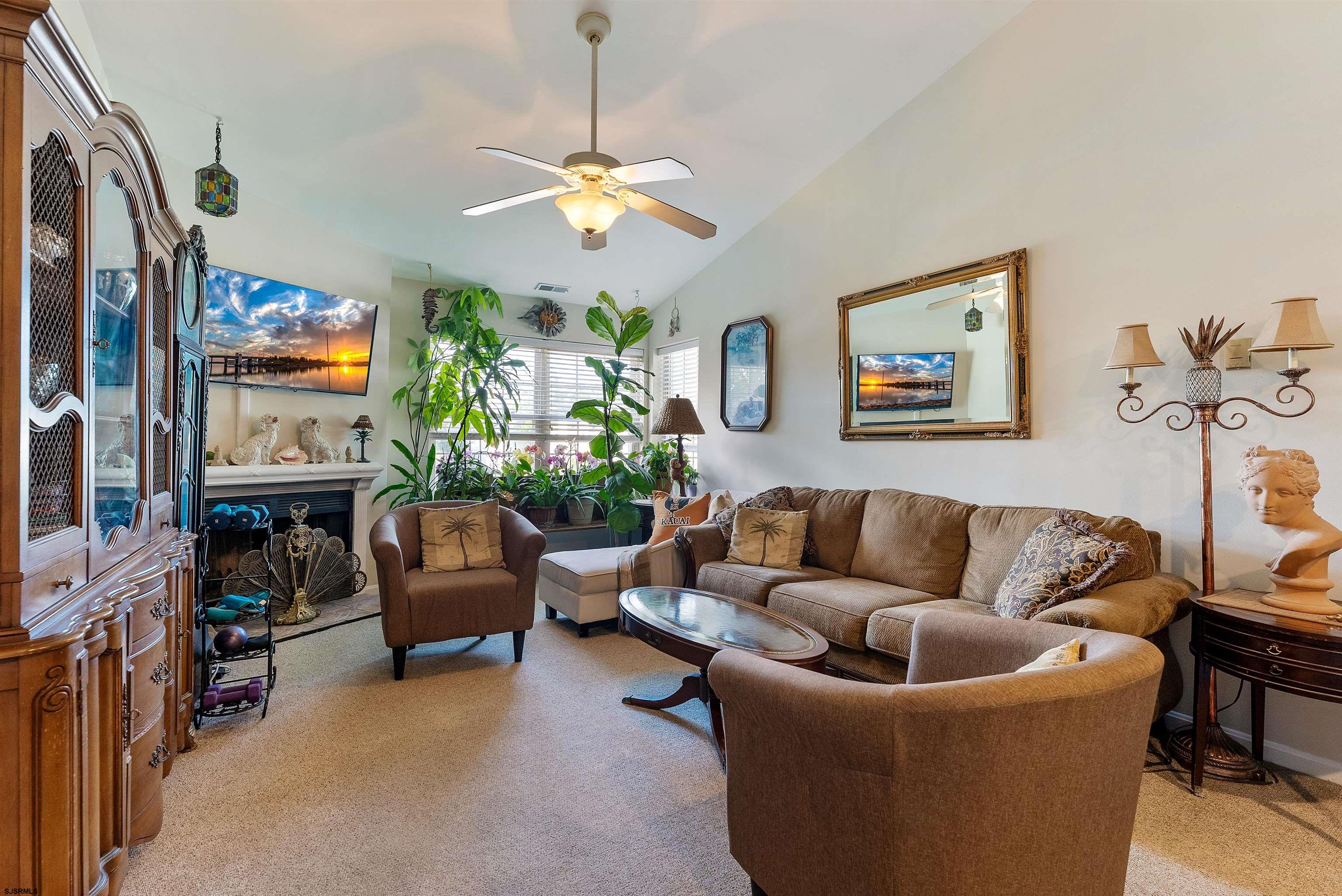 144 Meadow Ridge Road, Unit 144 Galloway Township, NJ 08205 - Photo 4 of 16 a living room with furniture a chandelier and a window