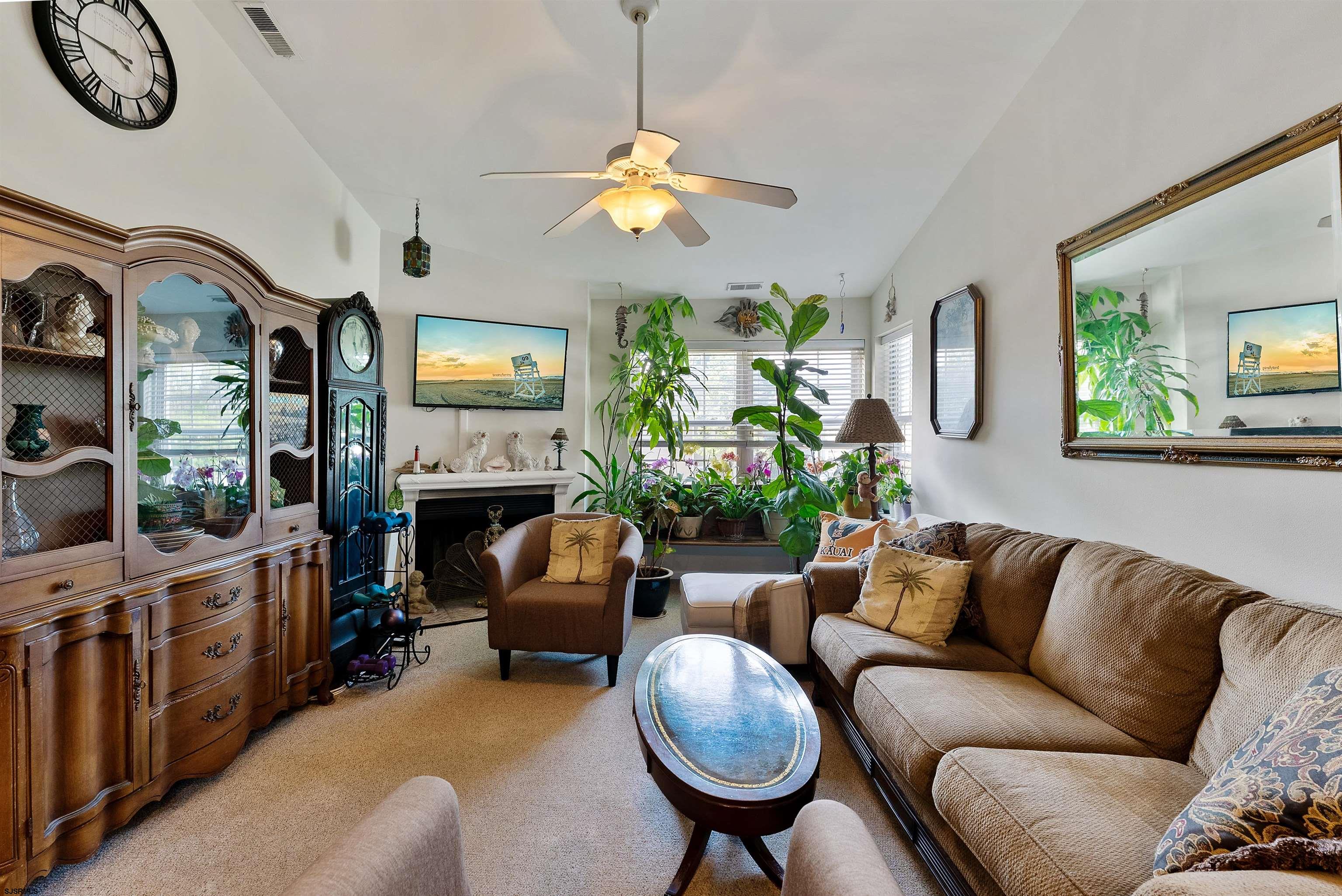 144 Meadow Ridge Road, Unit 144 Galloway Township, NJ 08205 - Photo 6 of 16 a living room with fireplace furniture and a window
