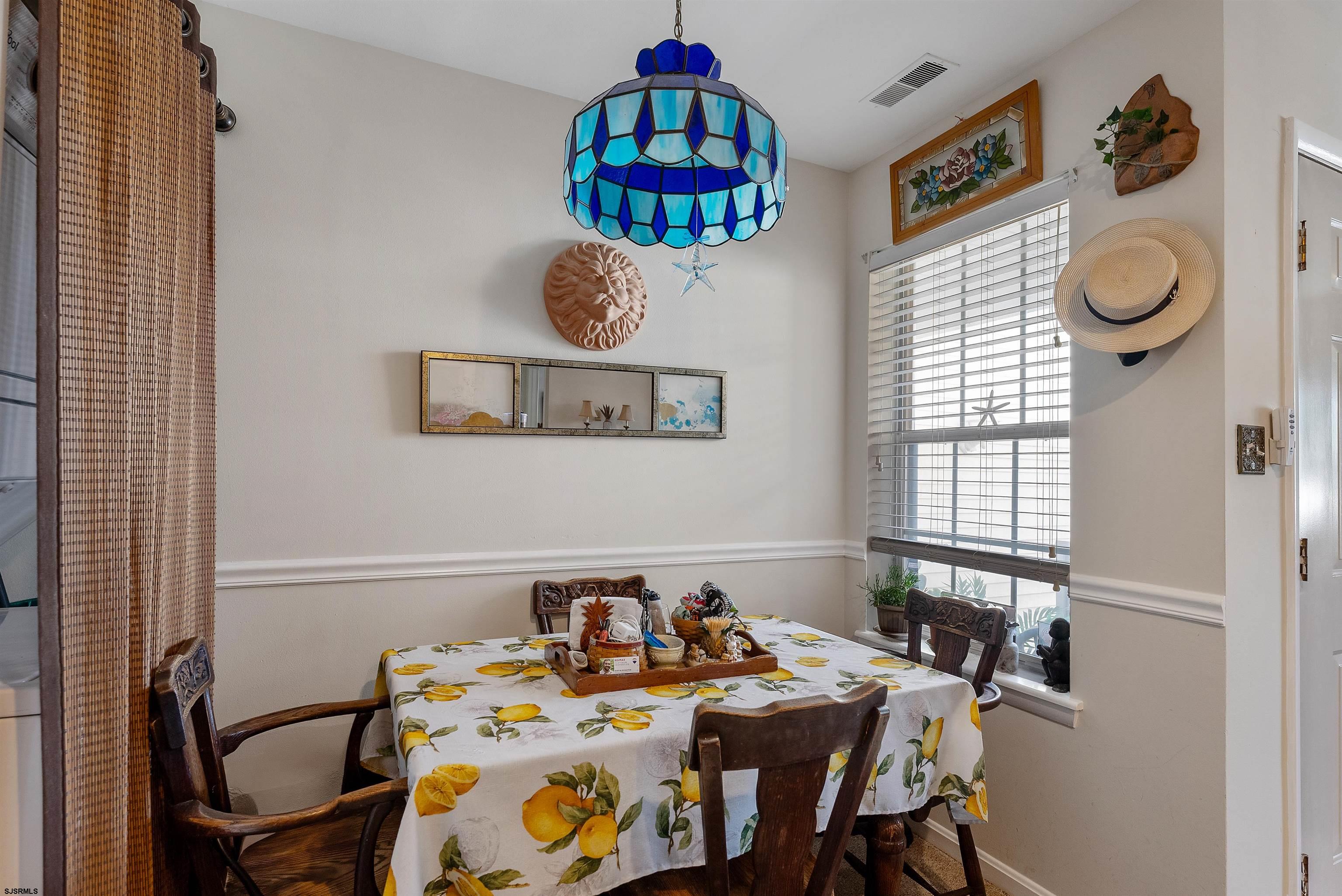 144 Meadow Ridge Road, Unit 144 Galloway Township, NJ 08205 - Photo 10 of 16 a view of a dining area with furniture and a window