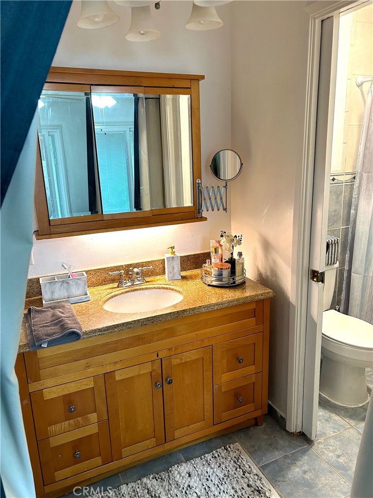 9530 Bexley Drive Pico Rivera, CA 90660 - Photo 15 of 22 a bathroom with a sink a toilet and a mirror