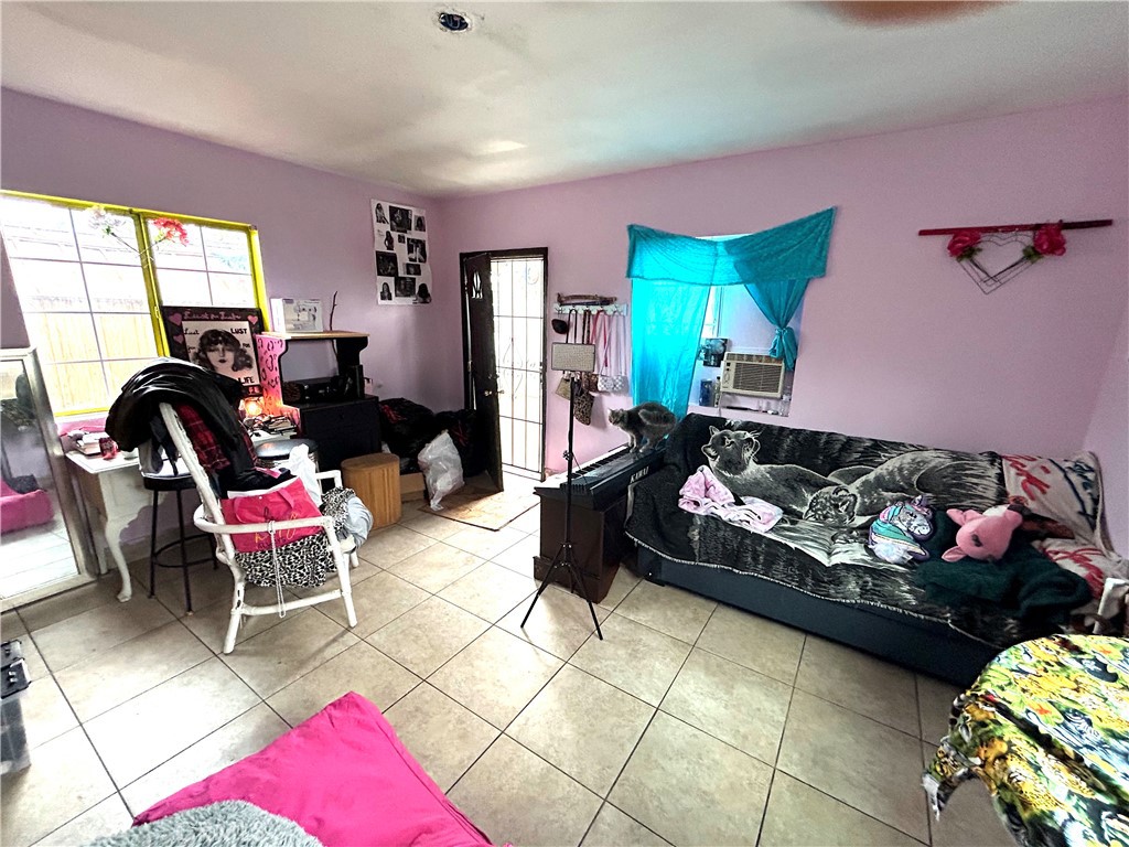 9530 Bexley Drive Pico Rivera, CA 90660 - Photo 22 of 22 a living room with furniture a rug and a floor to ceiling window
