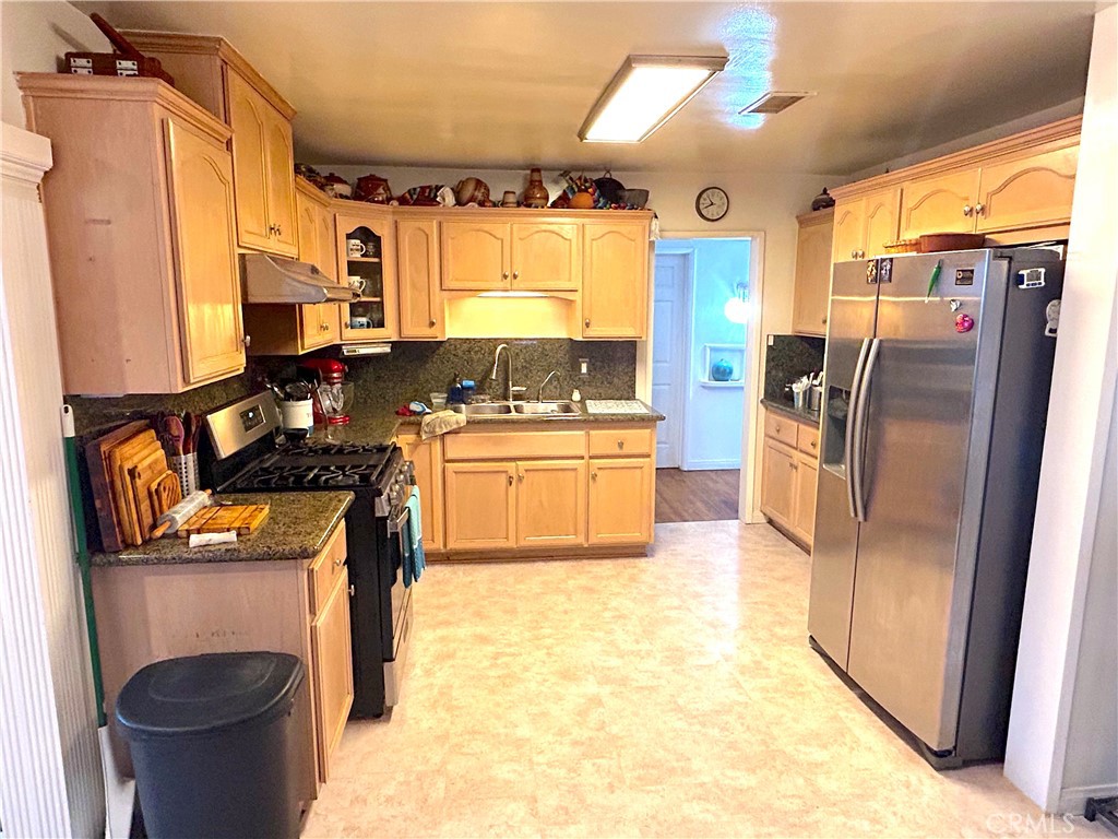 9530 Bexley Drive Pico Rivera, CA 90660 - Photo 9 of 22 a kitchen with stainless steel appliances granite countertop a refrigerator a stove and a sink