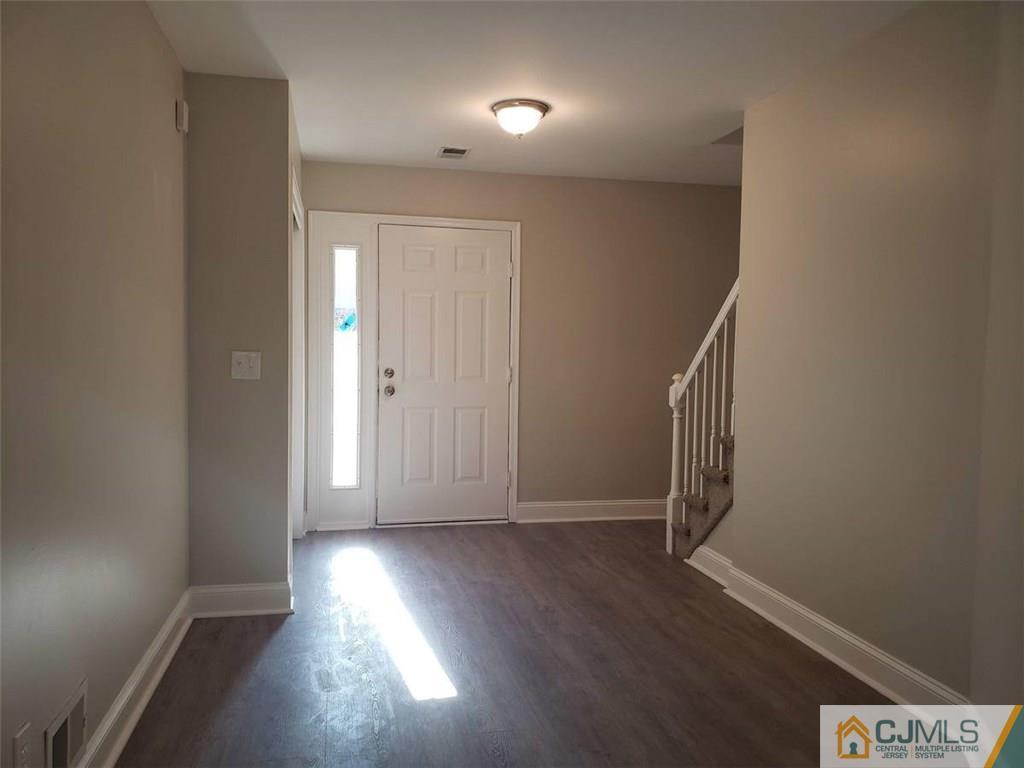 148 Redpine Loop Old Bridge, NJ 08857 - Photo 3 of 20 an empty room with wooden floor and windows