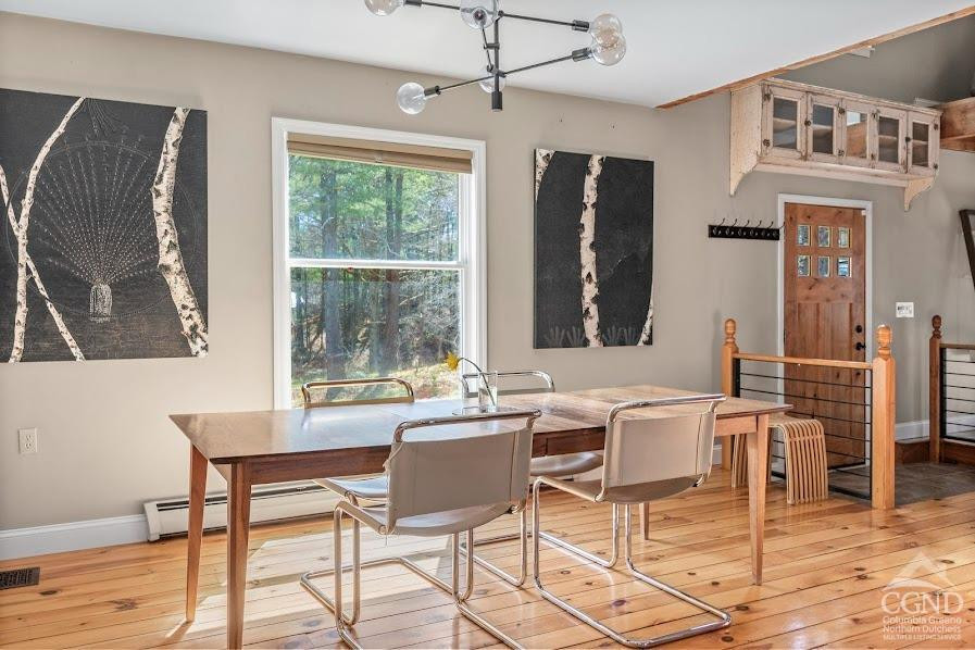 167 Dunbar Road Claverack, NY 12534 - Photo 13 of 37 a dining room with furniture a chandelier and wooden floor