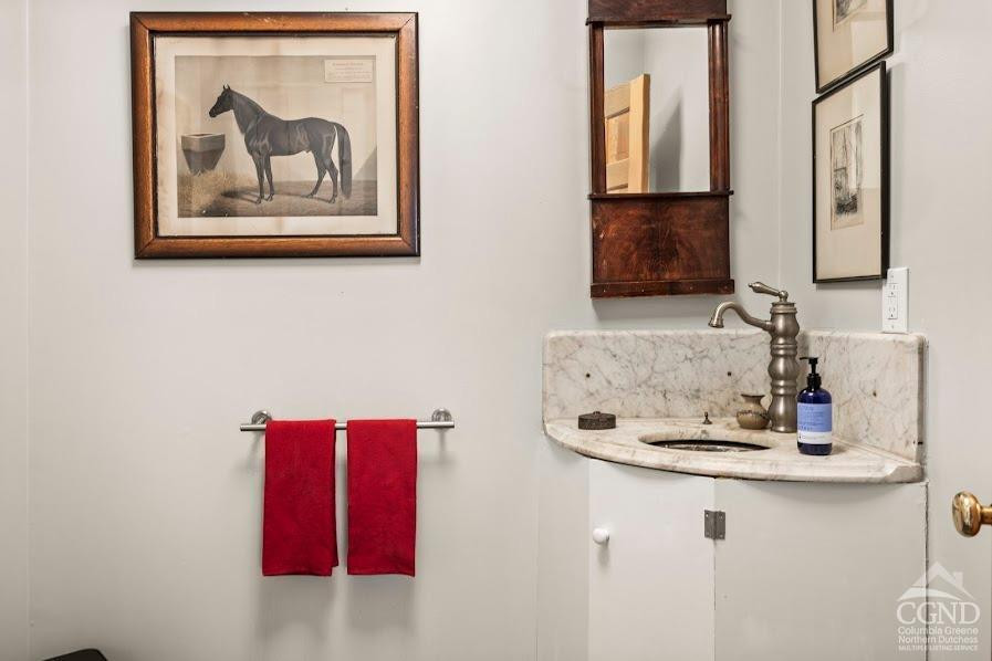 167 Dunbar Road Claverack, NY 12534 - Photo 14 of 37 a bathroom with a granite countertop sink a mirror and vanity