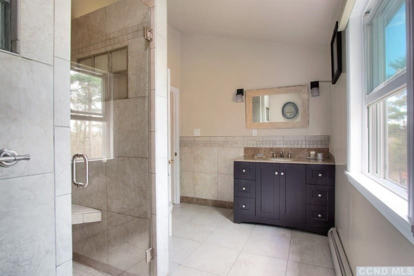 167 Dunbar Road Claverack, NY 12534 - Photo 18 of 37 a bathroom with a granite countertop sink a mirror and shower