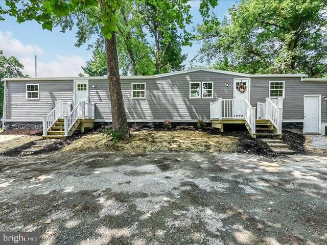 a backyard of a house with barbeque oven table and chairs