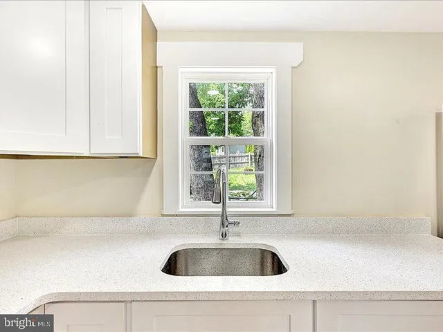 a kitchen with a sink and bathtub