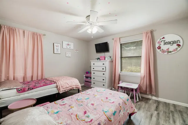 a bedroom with two beds and a chandelier