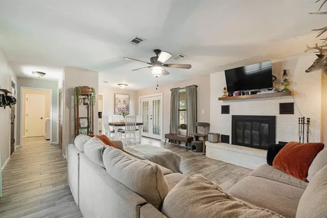 a living room with furniture fireplace and flat screen tv